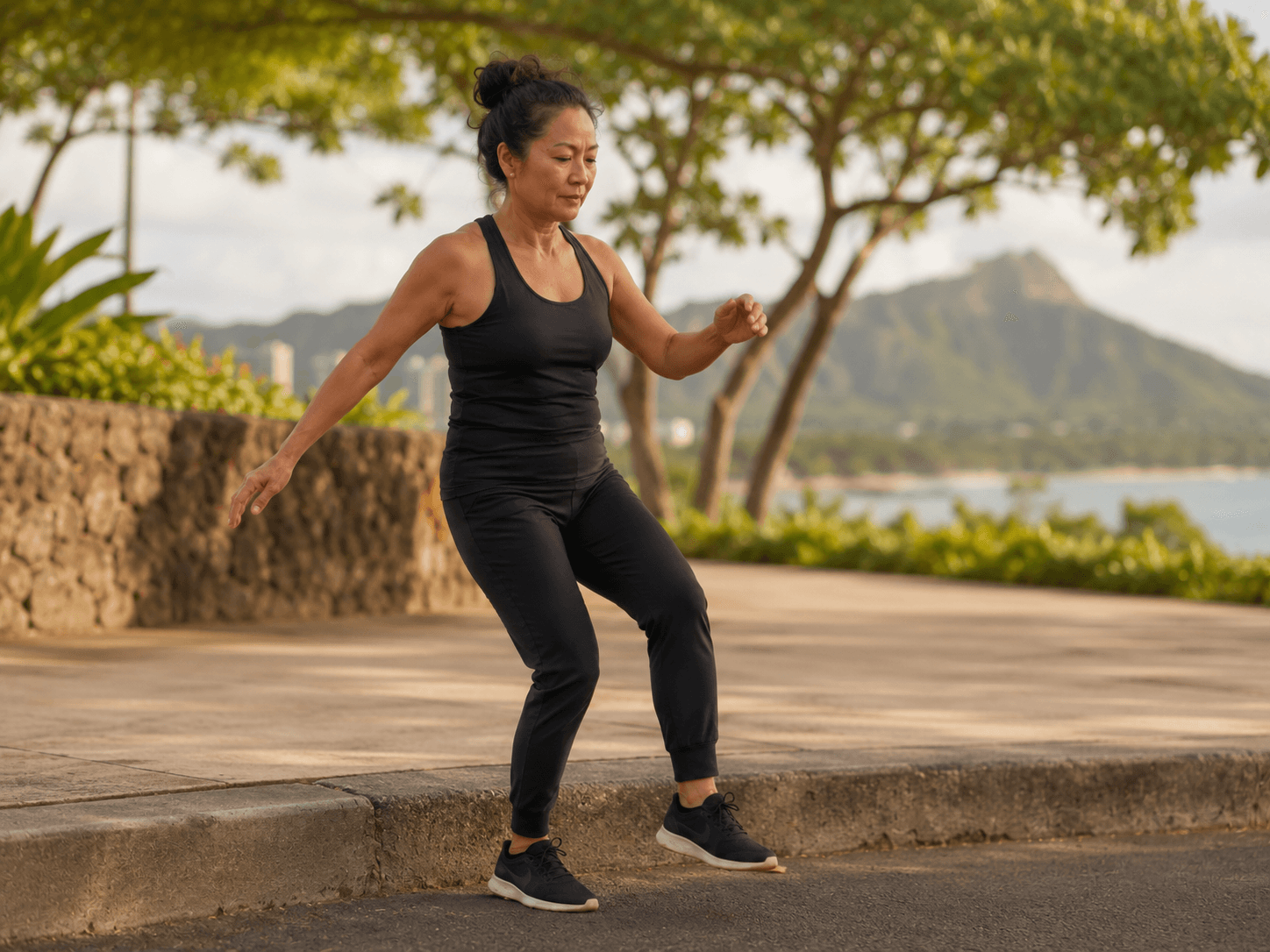 A woman catching her balance with her arms out after stepping unexpectedly off a curb
