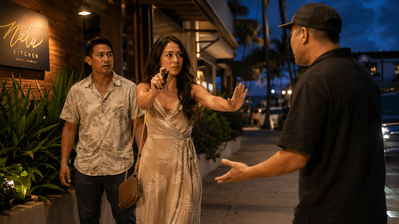 A woman holding a firm boundary with a hand raised toward an approaching stranger at night, a personal safety device in her other hand